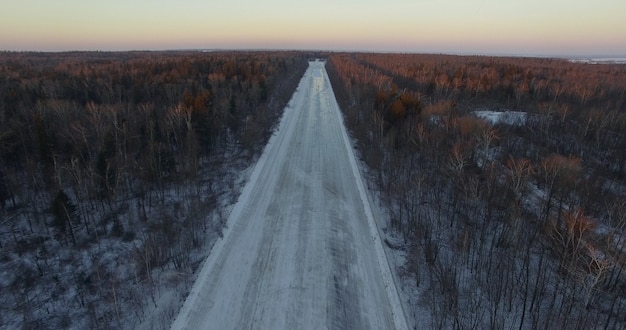 Vista aerea della strada vuota nei boschi invernali