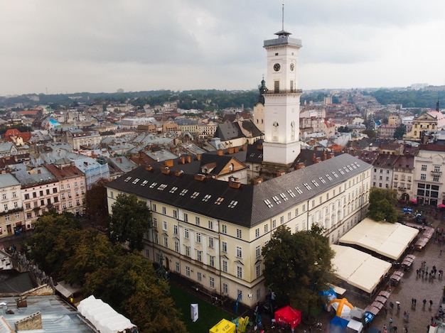 Aerial view of european central square with bell tower overcast rainy weather