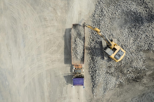 Aerial view of excavator scooping rocks