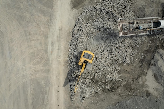 Aerial view of excavator scooping rocks