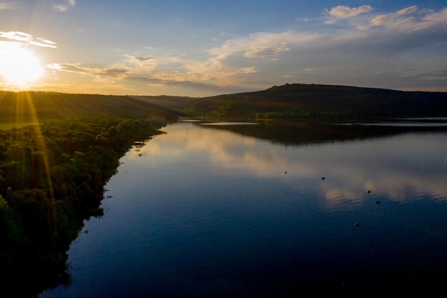 Aerial view of fisherman at the boat on golden sunset river silhouette of fishermen with his boat Fisherman life style