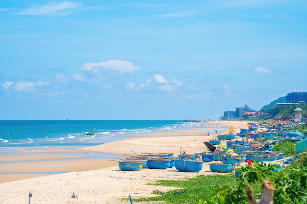 Aerial view of fishing village in Long Hai Phuoc Hai Tropical Seascape with a boat on sandy beach at cloudy Beautiful tropical beach with small boat for travel and vacation in holiday relax time