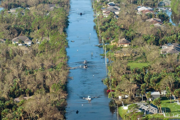 Aerial view of flooded street after hurricane rainfall with driving cars in Florida residential area Consequences of natural disaster