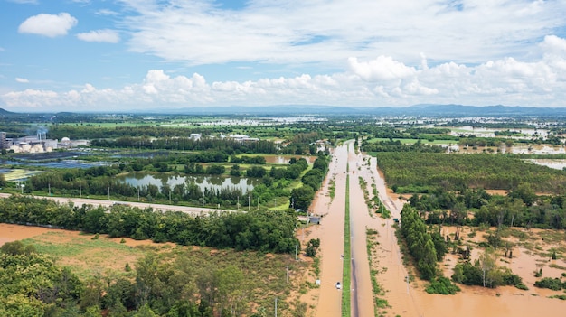 Aerial view of Flooded the village and Country road with car, View from above shot by drone