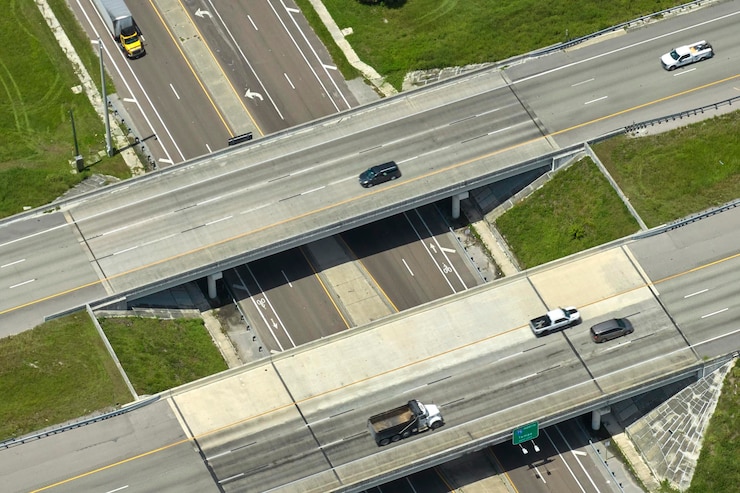 Photo aerial view of freeway overpass junction with fast moving traffic cars and trucks interstate transportation infrastructure in usa