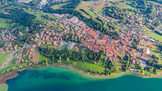 Aerial view from the drone of the landscape of a small town on the shores of lake Como, Italy.