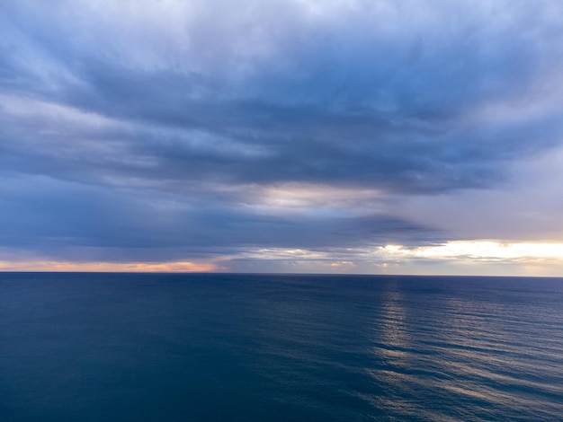 Aerial view from a flying drone of sunrise over ocean