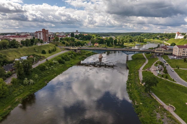 Aerial view from great height on wide river and huge bridge of old city