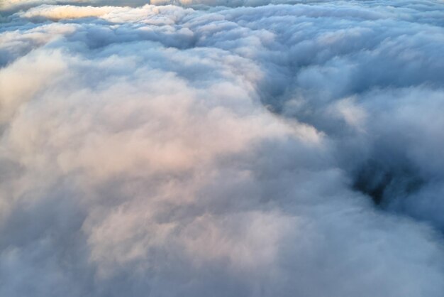 Aerial view from high altitude of earth covered with puffy\
rainy clouds forming before rainstorm.