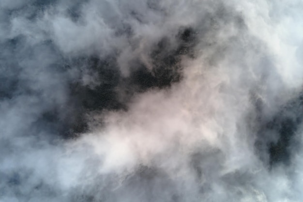 Aerial view from high altitude of earth covered with puffy\
rainy clouds forming before rainstorm