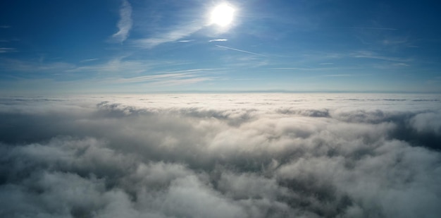 Aerial view from high altitude of earth covered with puffy\
rainy clouds forming before rainstorm