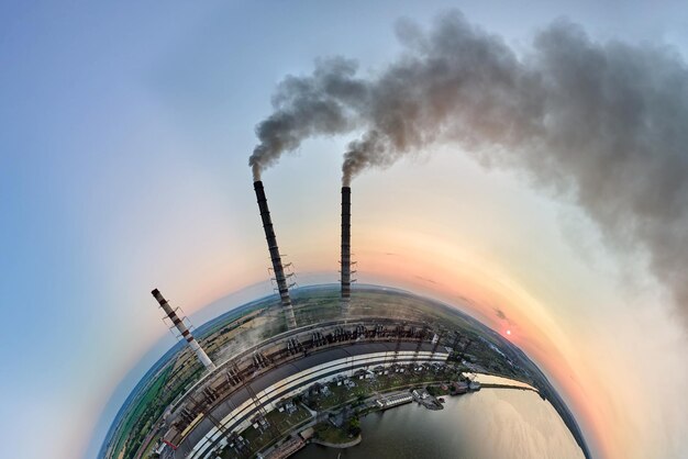 Aerial view from high altitude of little planet earth with coal power plant high pipes with black smokestack polluting atmosphere Electricity production with fossil fuel concept