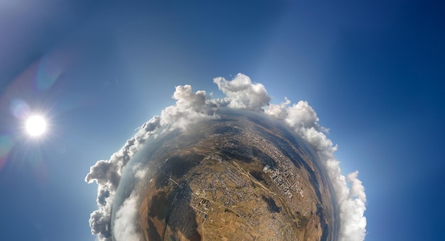 Aerial view from high altitude of little planet with distant\
city covered with puffy cumulus clouds flying by before rainstorm\
airplane point of view of landscape in cloudy weather