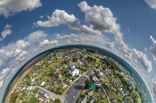 Aerial view from high altitude tiny planet in sky with clouds overlooking old town urban development buildings and crossroads Transformation of spherical 360 panorama in abstract aerial view