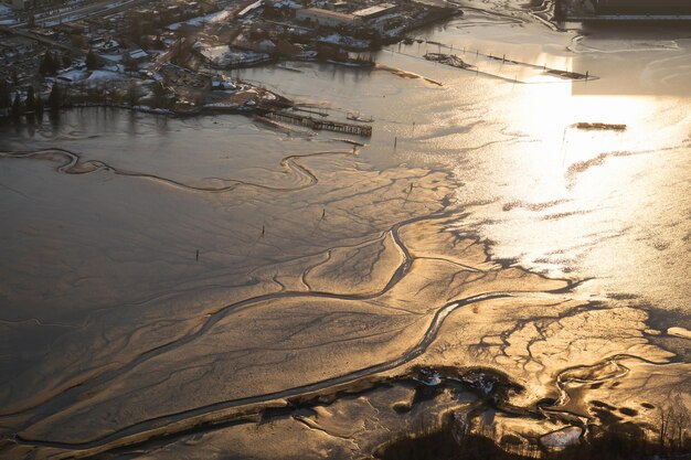 Aerial view from above of natural patterns in the sand during low tide