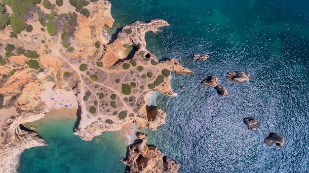 Photo aerial. view from the sky of the mountain capes on shores of portimao.