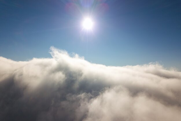 Aerial view from above of white puffy clouds.