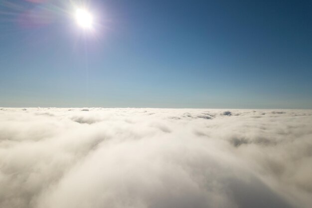 Aerial view from above of white puffy clouds.