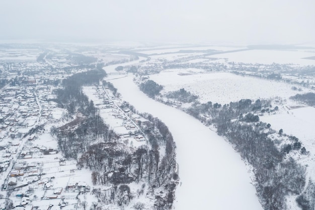 Aerial view of a frozen river The river is frozen and covered with snow severe frosts