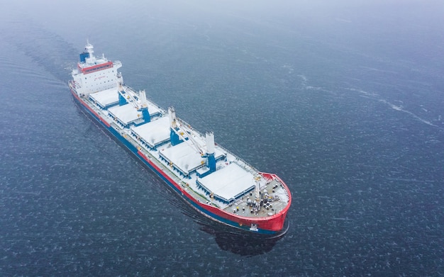 Aerial view of general cargo ship in the sea at winter time