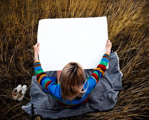 Aerial view of girl holding blank placard