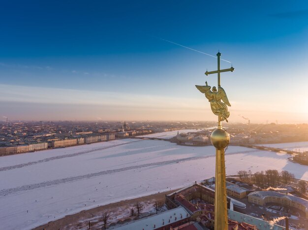 Aerial view of golden angel and cross on spike of the peter and paul cathedral in saint petersburg a...