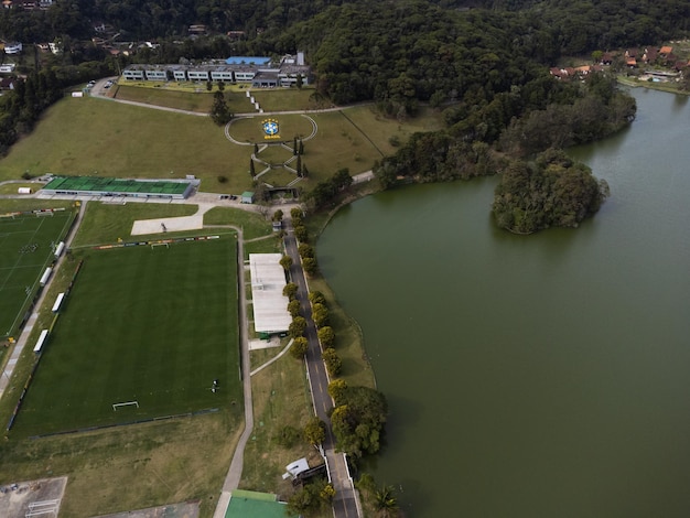 Aerial view of granja comary and the lake in the city of\
teresopolis mountain region of rio de janeiro brazil drone photo\
brazilian football team and brazilian football confederation