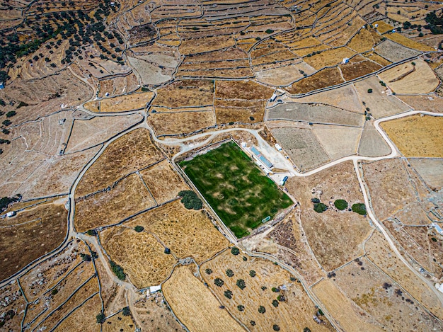 Aerial view on a green football field during drought on sifnos island Greece