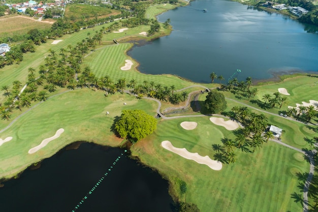 Aerial view of the green golf course in thailand beautiful
green grass and trees on a golf field with fairway and putting
green in summer season