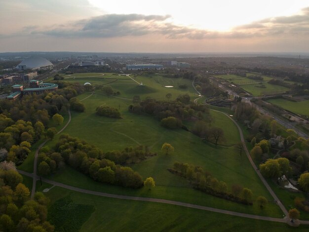 Aerial view of green landscape against sky during sunset