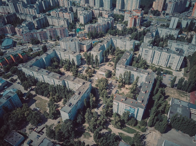 Aerial view of growing city drone view of new building complex\
in city center with houses