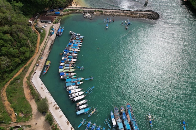 aerial view of harbor in Indonesia. Ships and boat anchoring in dock harbor. Indonesian landscape.