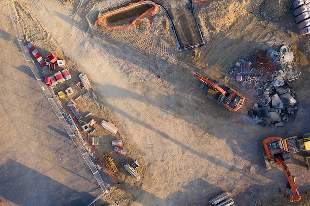 Aerial view over heavy machinery on a building construction site
