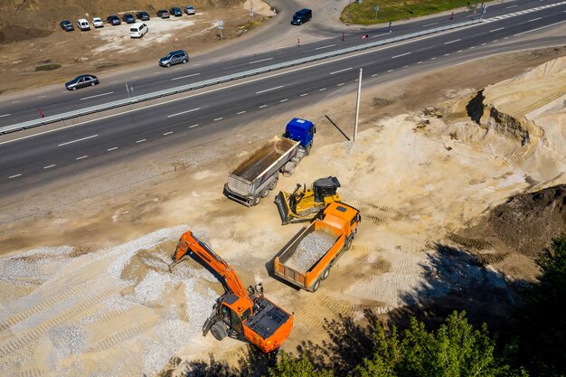 Aerial view of heavy machinery for crushing and collecting\
stone limestone sand and gravel materials for asphalt producers and\
paving road construction