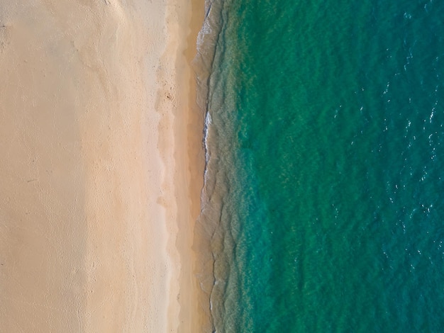 Aerial view high angle view Topdown seawater wave on sandy beach Aerial view above beach sea in tr