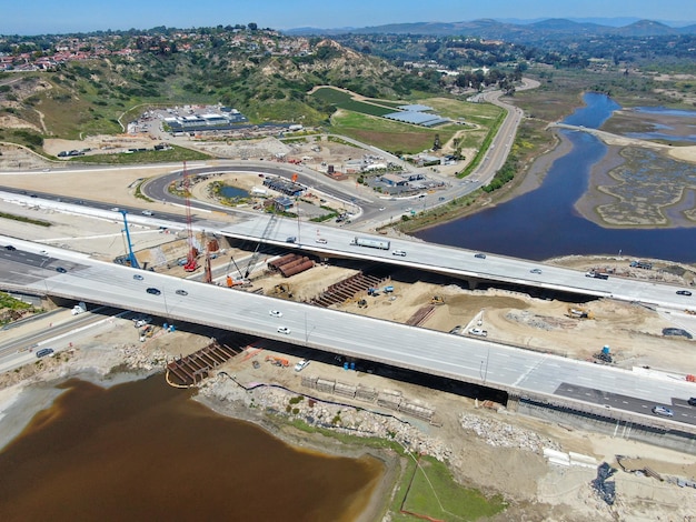 Aerial view of highway bridge construction over small river San Diego California USA