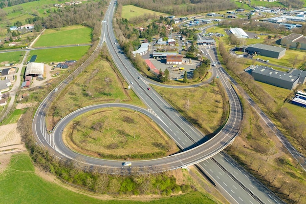 Aerial view of highway road intersection with fast moving heavy traffic Intercity transportation with many cars and trucks