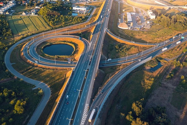 Aerial view of highway and roundabout at sunset in the evening