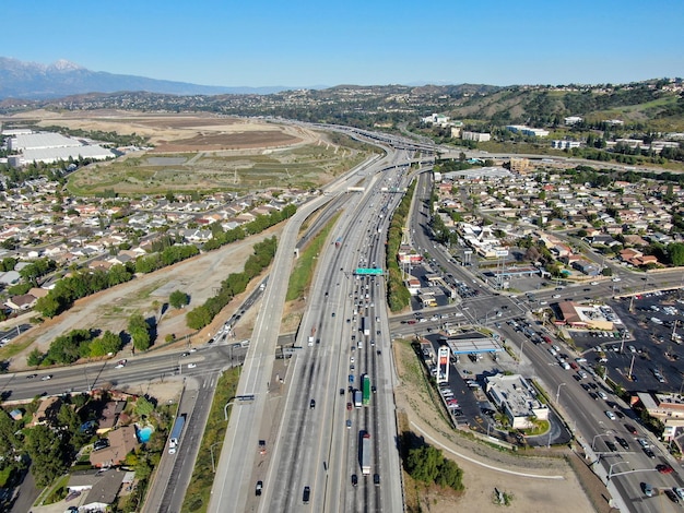 Aerial view of highway with traffic surrounded by houses in Diamond Bar City California