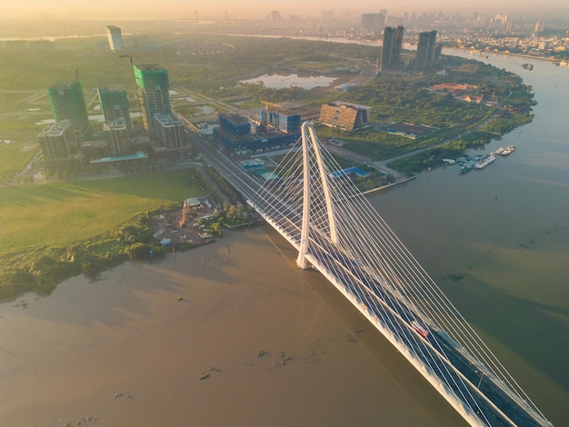 Aerial view of ho chi minh city skyline and skyscrapers on\
saigon river center of heart business at downtown morning view far\
away is landmark 81 skyscraper