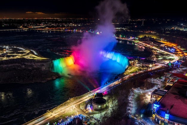 Aerial view of Horseshoe Falls winter illumination in twilight time Niagara Falls City downtown