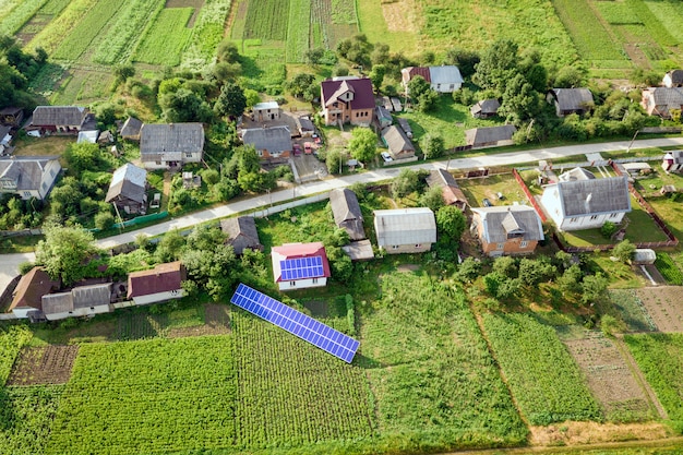 Aerial view of a house with blue solar panels.