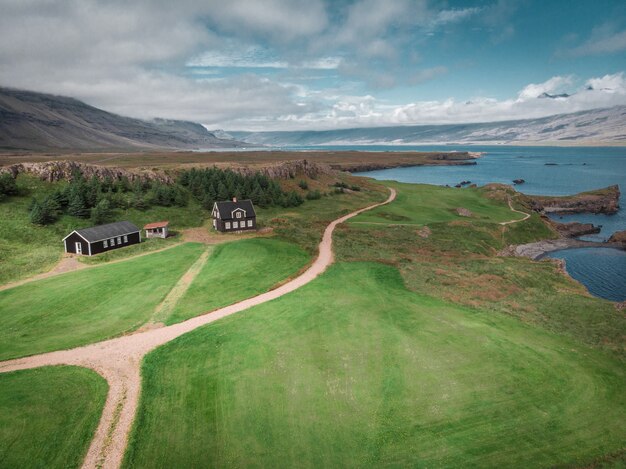 Aerial view of houses and cars on seashore snaefellsnes icelan