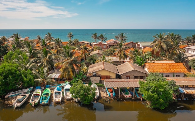 Aerial view of houses on the shoreline in negombo