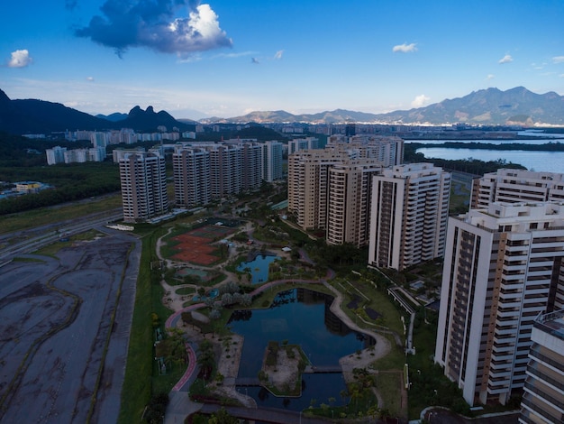 Aerial view of Ilha Pura Park at sunset. In the background, the hills of Rio de Janeiro, Brazil and the JacarÃÂ©pagua lagoon. Sunny Day and some clouds. Drone take.