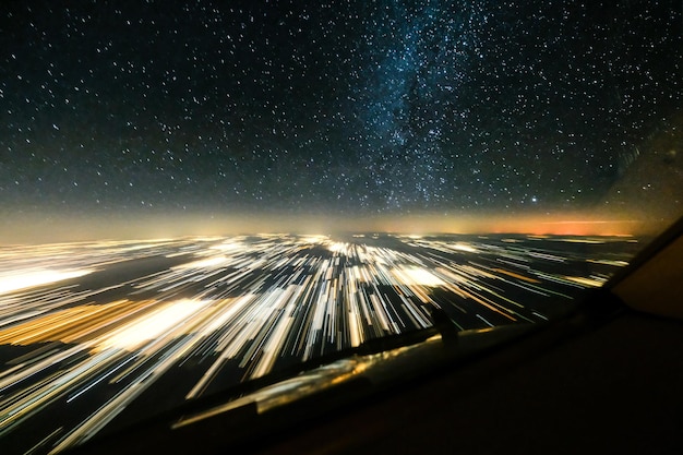 Photo aerial view of illuminated car against sky at night