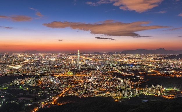 Aerial view of illuminated city at sunset