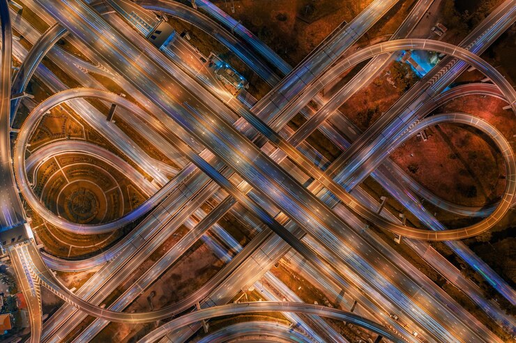 Photo aerial view of illuminated elevated road at night
