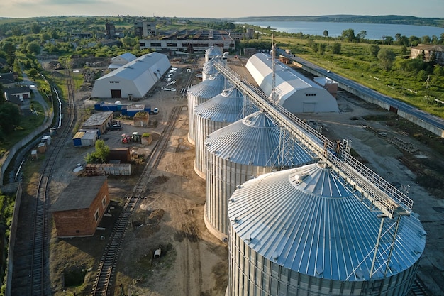 Aerial view of industrial ventilated silos for long term storage of grain and oilseed Metal elevator for wheat drying in agricultural zone
