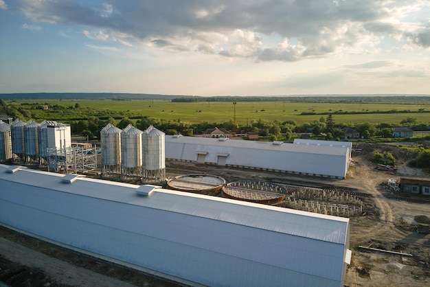 Aerial view of industrial ventilated silos for long term storage of grain and oilseed Metal elevator for wheat drying in agricultural zone